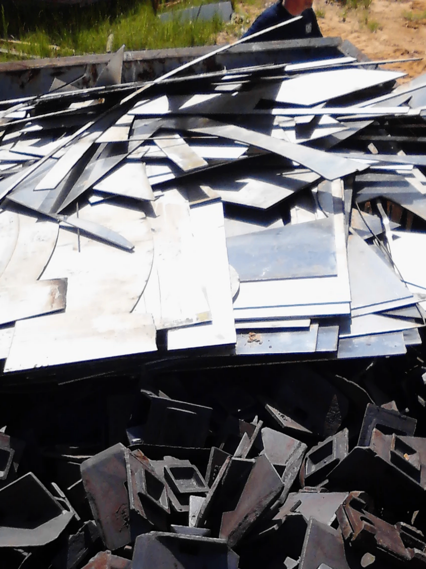 Loose sheet-metal cutoffs and prep-scrap collected in a work area, ready to be baled