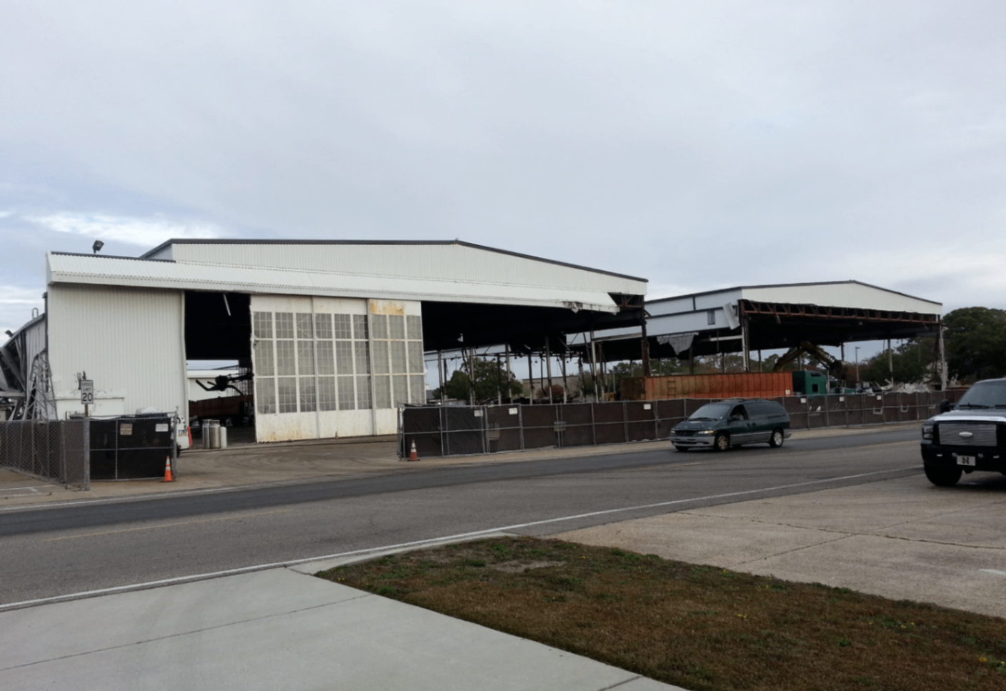 Covered outdoor processing yard with sorted scrap piles under a metal roof at the CW Mobile Service facility
